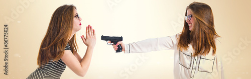 Girl shooting her sister