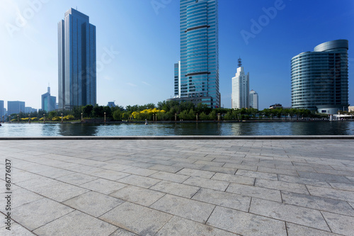 modern buildings and empty road in urban city at riverbank