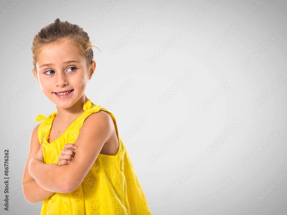 Blonde little girl walking with her arms crossed Blonde little girl walking with her arms crossed