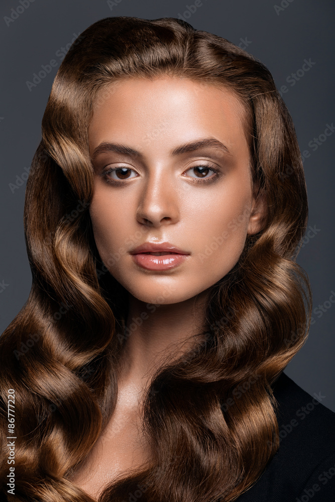 young woman with long glossy curly hairstyle young woman with long glossy curly hairstyle