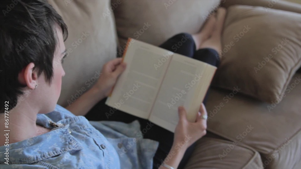 woman reading a book on the couch woman reading a book on the couch