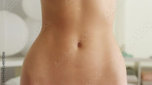Closeup of woman's flat stomach