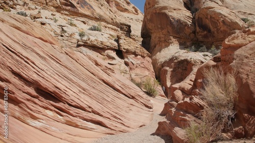 People hiking in a deep desert slot canyon in Southern Utah photo