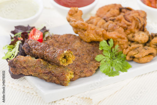South Asian Starters - Selection of seekh and shami kebabs, mushroom and chicken pakoras and onion bhajjis. Served with salad, mint raita, lime pickled and chilli sauce.
 photo