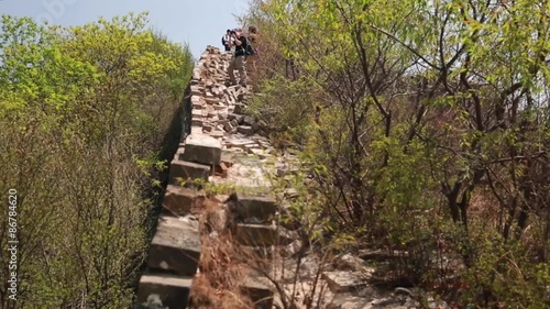 hikers on the unrestored section of the great wall of china photo