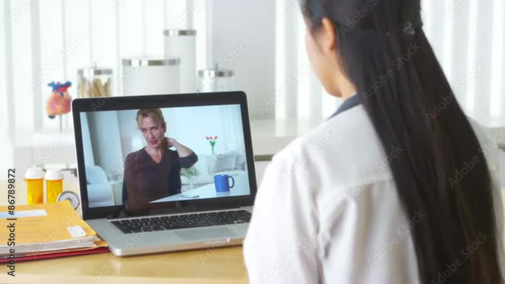 Chinese doctor video chatting with elderly patient Chinese doctor video chatting with elderly patient