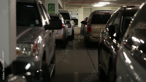 cars and people inside a busy parking garage steadicam