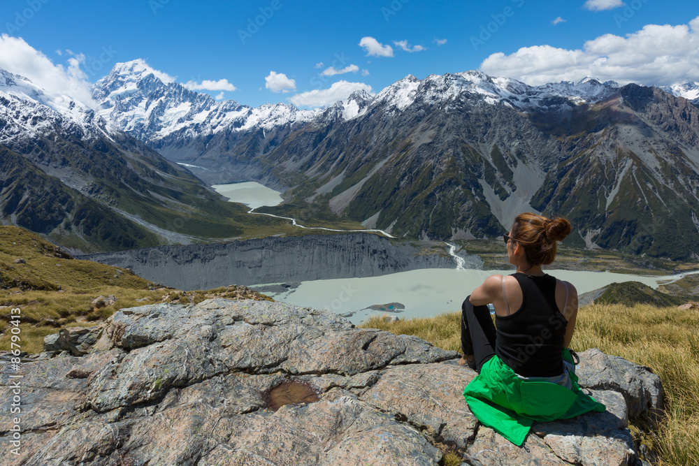 Woman Traveler with Backpack hiking in Mountains Woman Traveler with Backpack hiking in Mountains