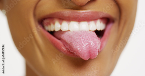 Photo Close up of African woman with white teeth smiling and sticking tongue out