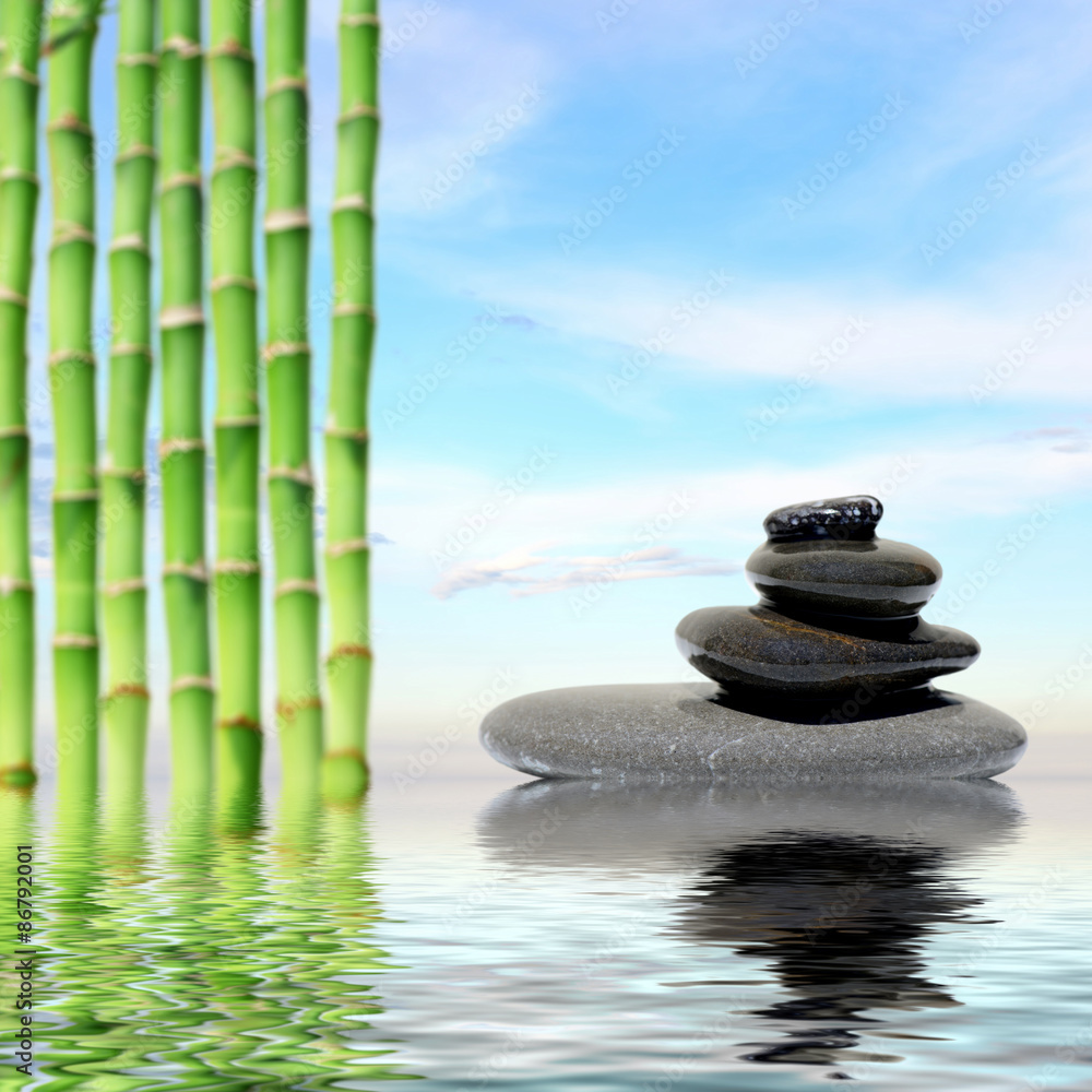 Obraz premium Zen spa concept background-Zen massage stones and bamboo reflected in water