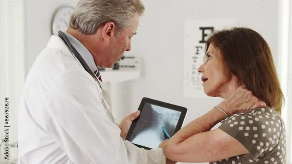 Senior Doctor explaining xrays to elderly patient Senior Doctor explaining xrays to elderly patient