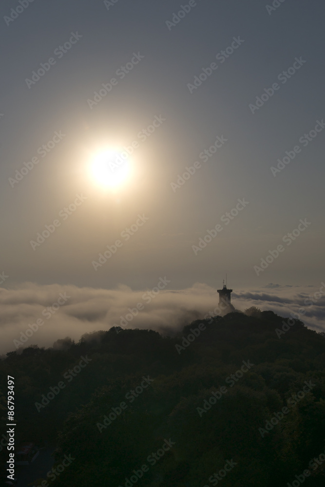 A lonely tower on the top of high mountain in fog. View from big wheel, Russia, Sochi A lonely tower on the top of high mountain in fog. View from big wheel, Russia, Sochi