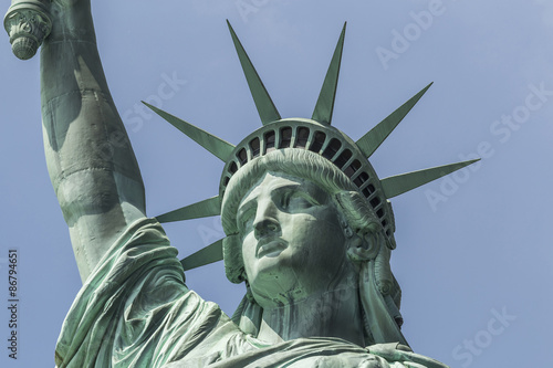 Closeup of Statue of liberty with blue sky in background