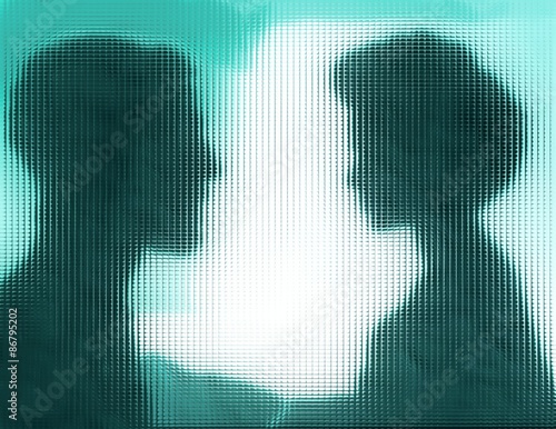 Profiles of man and woman behind blue glass