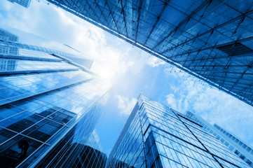 Modern business skyscrapers, high-rise buildings, architecture raising to the sky, sun