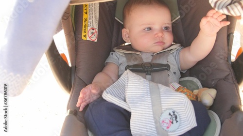 Newborn baby startled in his carseat