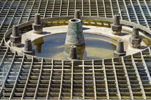 Empty fountain. Classic water source grid. photo