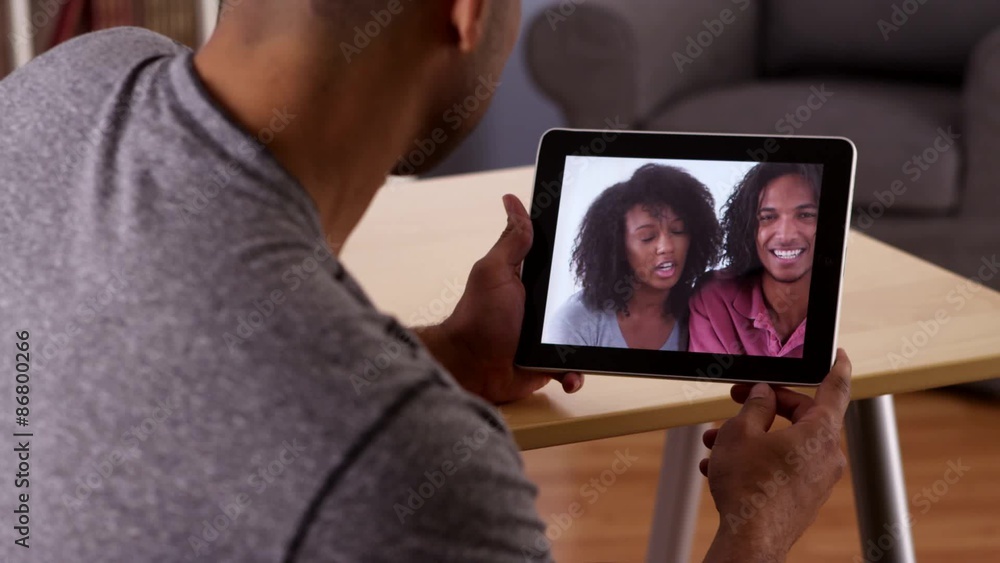 African man talking to relatives with tablet African man talking to relatives with tablet