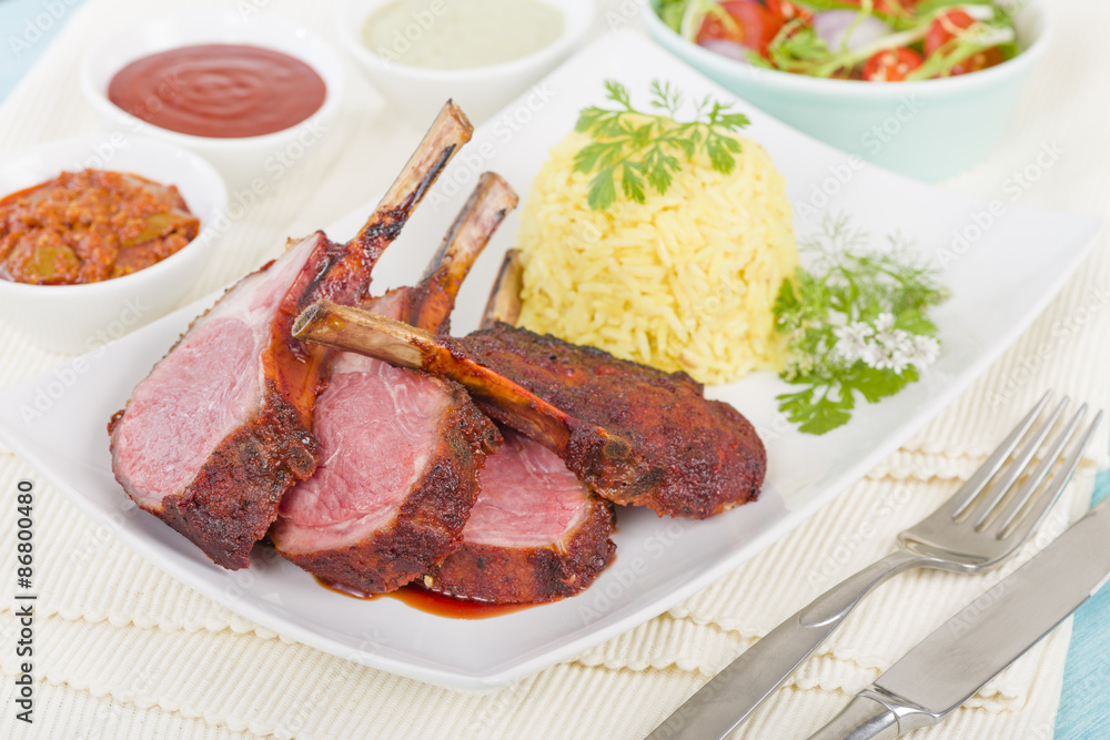 Lamb Cutlets - Spicy roasted lamb cutlets served saffron rice, salad and dips. Lamb Cutlets - Spicy roasted lamb cutlets served saffron rice, salad and dips.