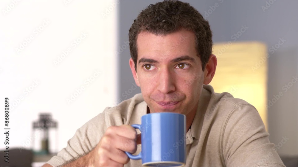 Man drinking coffee while looking away Man drinking coffee while looking away
