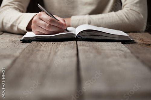 woman writing in a notebook