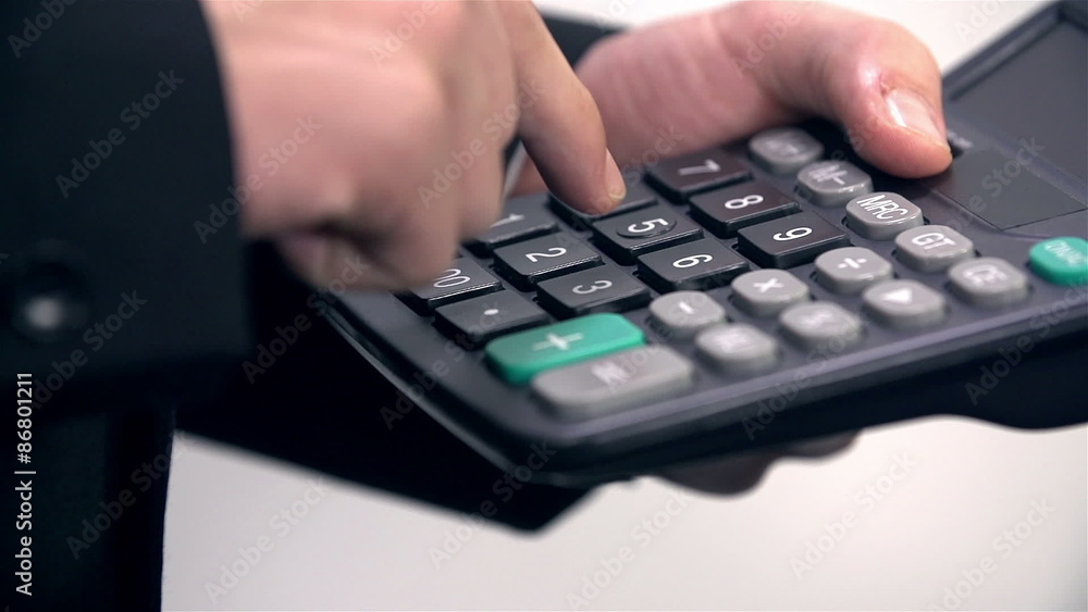 Close up on typing on calculator Close up on typing on calculator