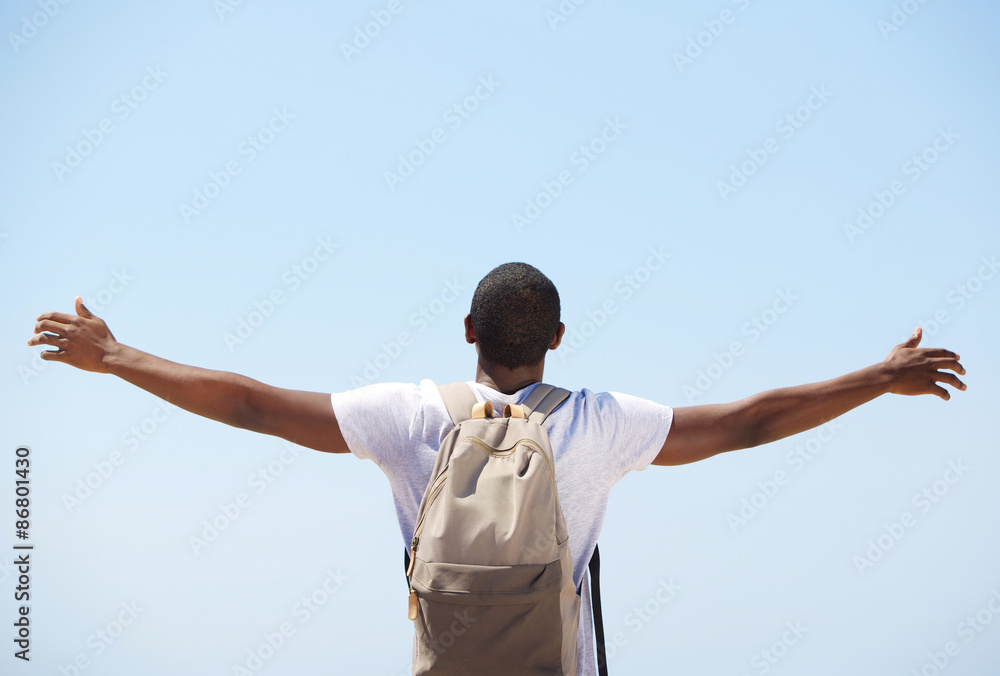 Young black man standing with arms outstretched Young black man standing with arms outstretched