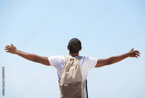 Young black man standing with arms outstretched