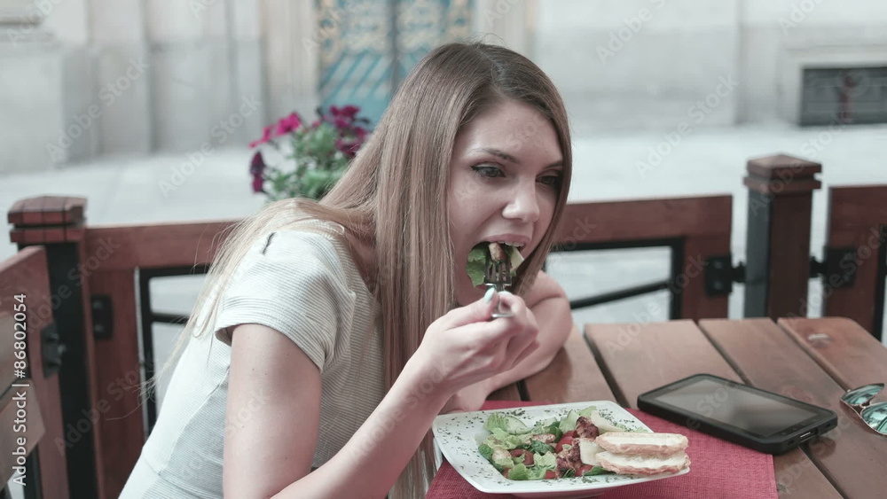 woman eating in restaurant chicken Cesar salad woman eating in restaurant chicken Cesar salad