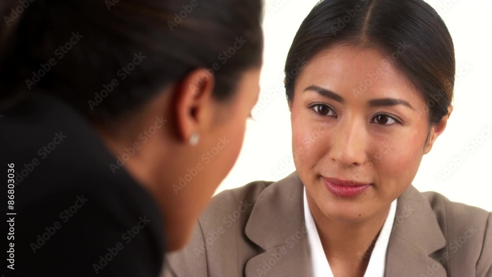 Japanese businesswoman talking with Mexican colleague Japanese businesswoman talking with Mexican colleague