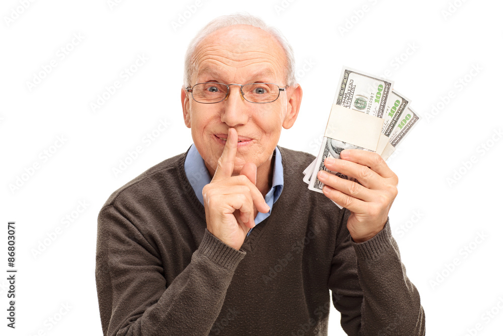Senior gentleman holding three stacks of money Senior gentleman holding three stacks of money