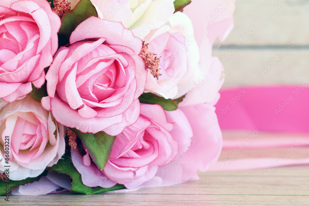 Pink roses against a wood wall Pink roses against a wood wall