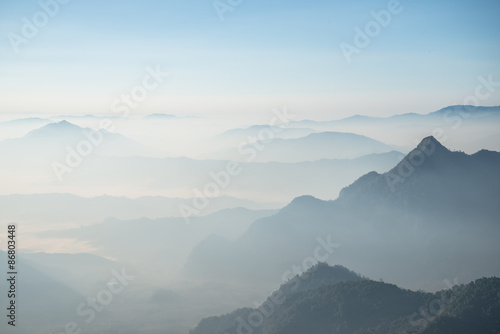 Scenery view of the mountains in the mist layer background. View from Phu Chi Fah in Chiang Rai province of Thailand.