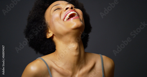 Slow pan up casual black woman laughing and smiling