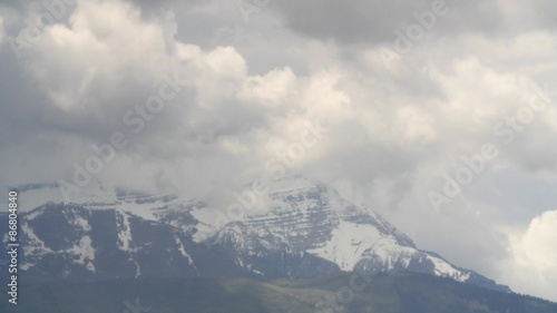 Timelapse of storm clouds building over mountain photo