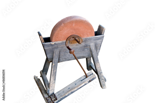 Foto Ancient grindstone on a white background.