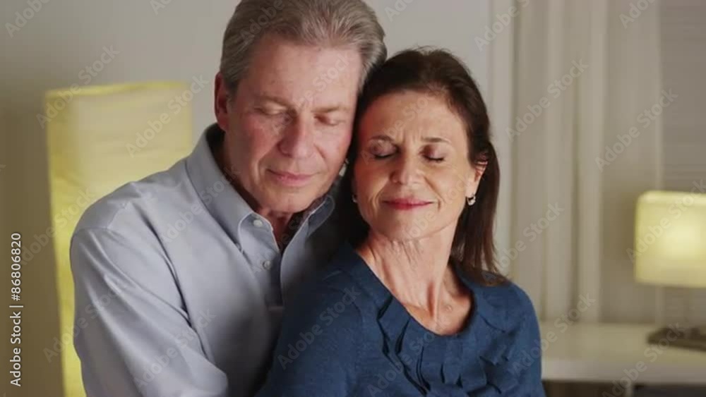 Elderly couple swaying back in forth in living room Elderly couple swaying back in forth in living room