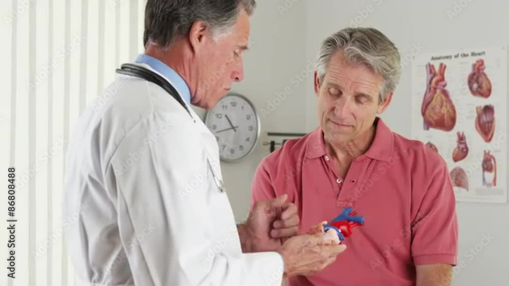 Senior doctor explaining heart to elderly patient Senior doctor explaining heart to elderly patient