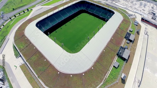 Flying over soccer stadium with green lawn photo