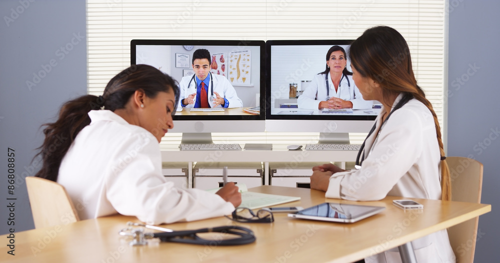 Professional team of multi-ethnic medical doctors having a video conference Professional team of multi-ethnic medical doctors having a video conference