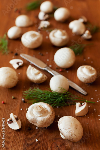 Cultured mushrooms champignons on wooden rustic background