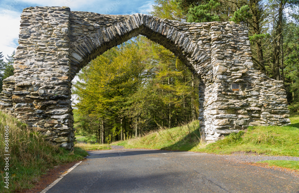 Obraz premium The Jubilee Arch, old graceful stone archway over minor road.