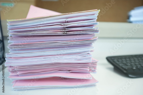 Many piles of papers on the desk