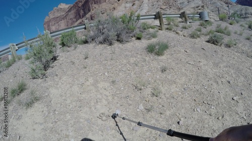 Man moving Great Basin Rattlesnake away from a camp photo