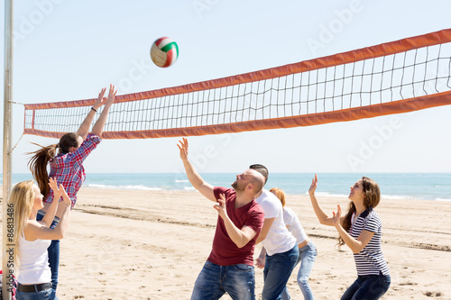 People play volleyball on beach