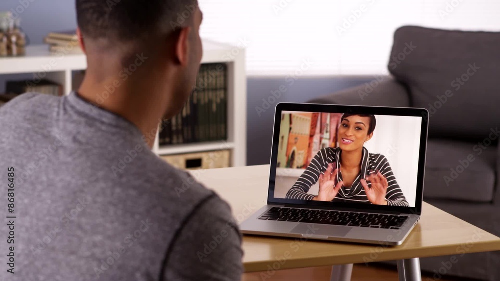 Black siblings video chatting on laptop Black siblings video chatting on laptop