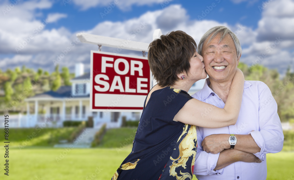 Affectionate Senior Chinese Couple In Front of House and Sign Affectionate Senior Chinese Couple In Front of House and Sign
