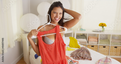 Young Mixed race woman trying to figure out what to wear