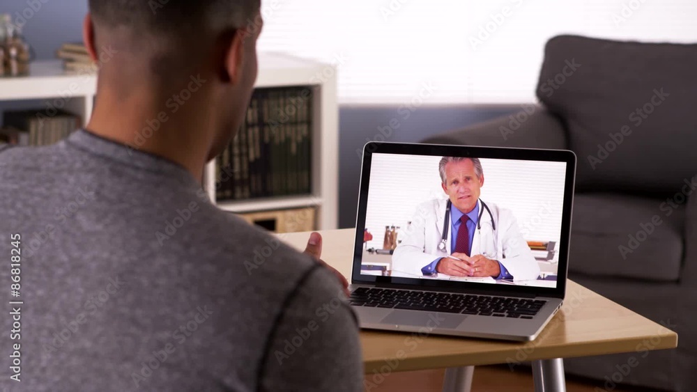 Black patient discussing health problems with doctor online Black patient discussing health problems with doctor online