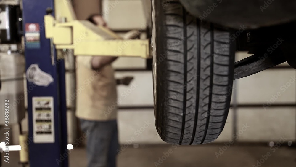 auto mechanic checking the tire pressure auto mechanic checking the tire pressure